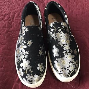 Black & metallic slip ons